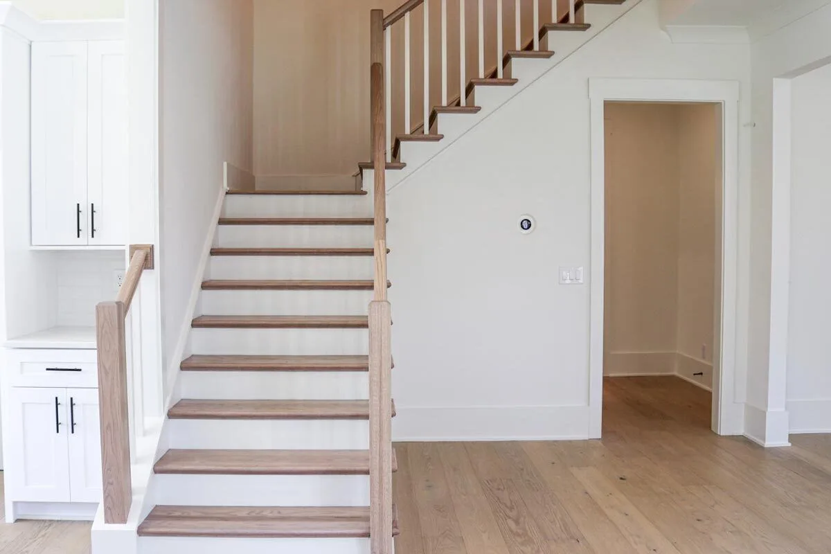 Staircase with railing and steps in a wooden style.