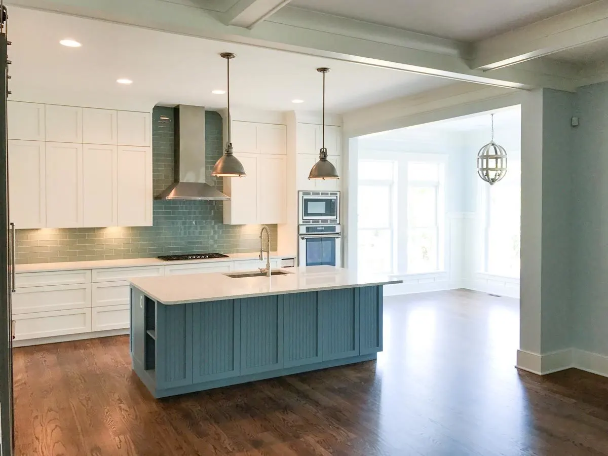 White marble counter table with dark blue shade base kitchen island.