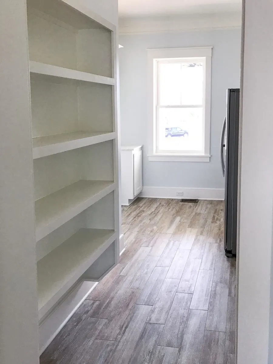 Inside the pantry is a shelves and a window view.