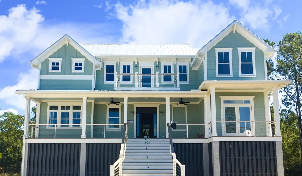 A wide front porch with white painted stairs.