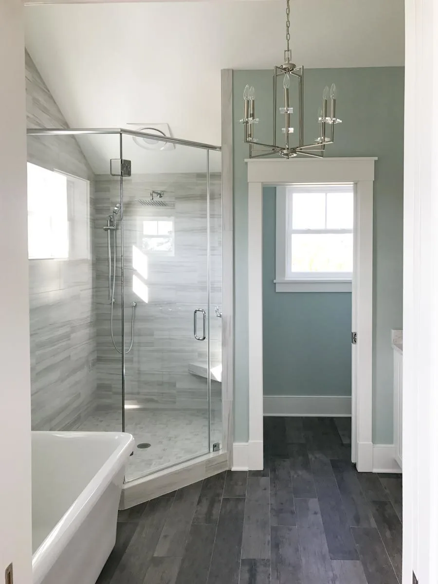 Shower area framed with glass in the bathroom.