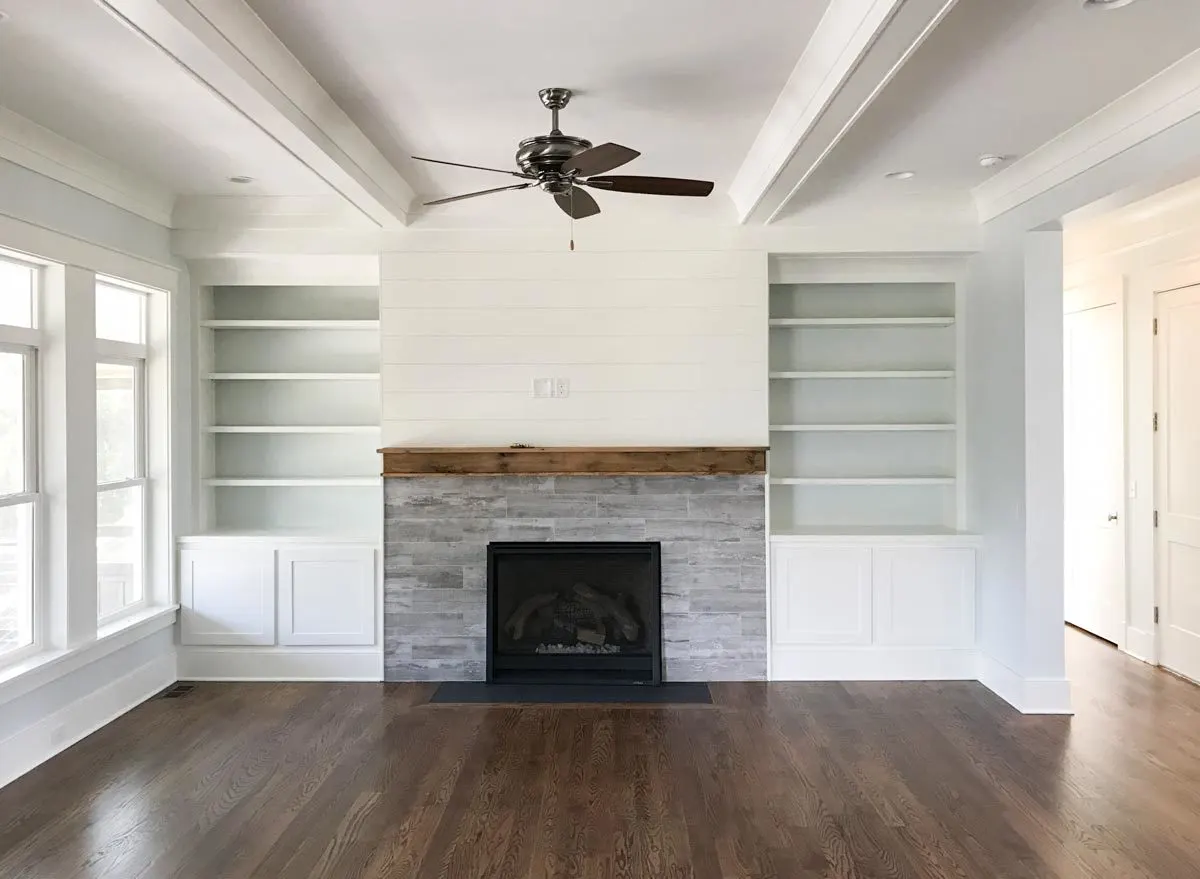 The living room has an excellent fireplace and wooden floors.