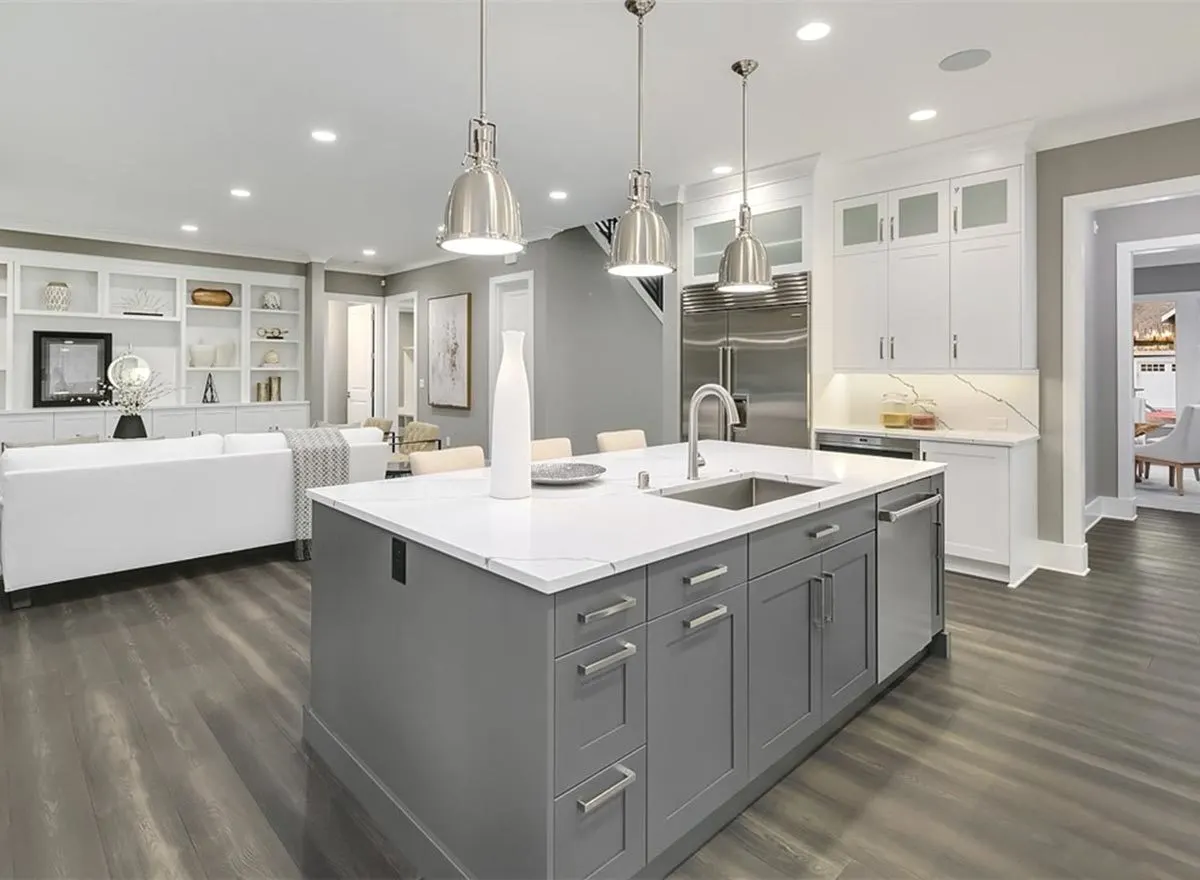 Above the kitchen island is a silver pendant chandelier.