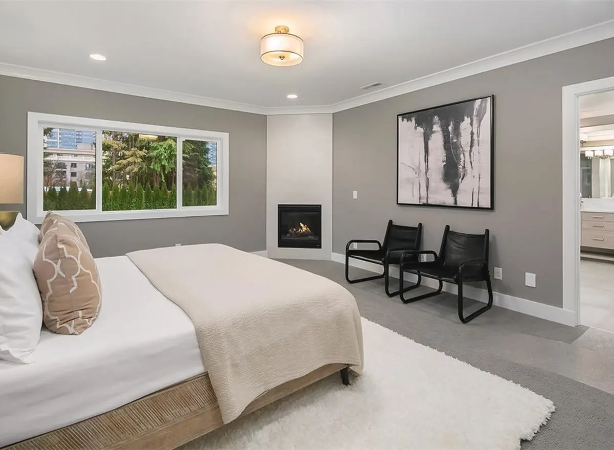 The master bedroom has a fireplace with two black folding seats.