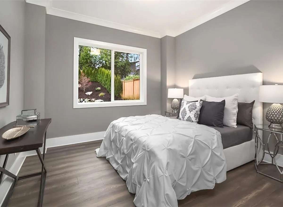 A cozy bedroom with a window overlooking the outdoors.