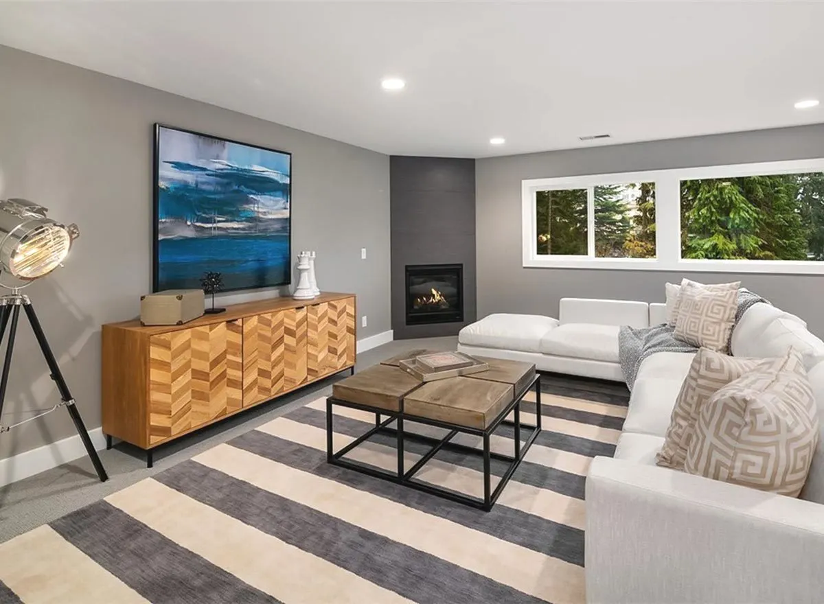 Lounge space includes a sofa, tables, and an ad rack in a sophisticated wooden style.