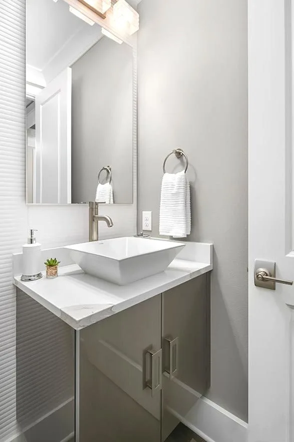 Vanity with a trapezoidal sink and a marble counter.