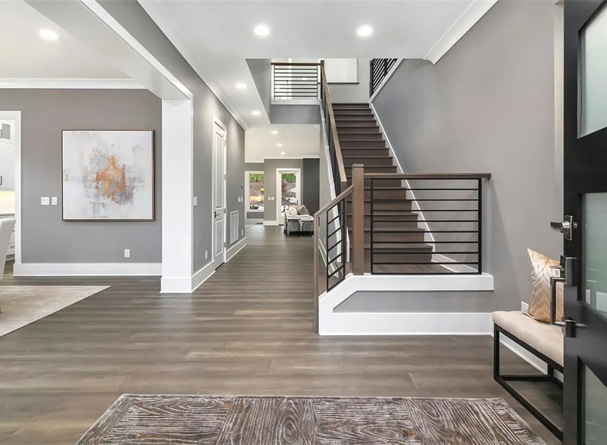 The house's foyer features a stunning wood design floor inside.