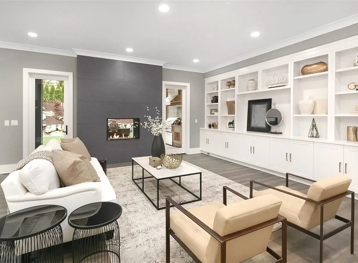 A great room space with a sleek pattern and shelving walls painted white.