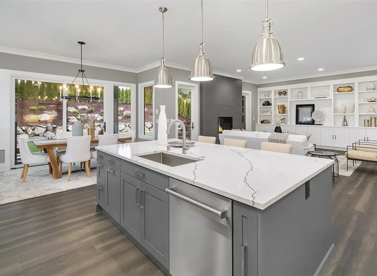 An island with a marble countertop, a sink, and a dish washer.