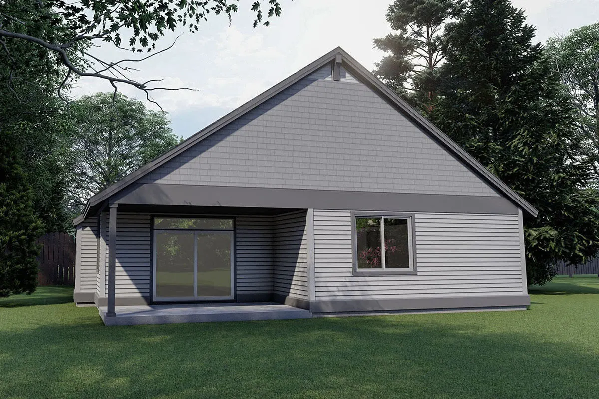 The covered patio with a sliding glass door at the back of the home.