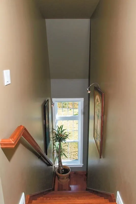 The sturdy wood steps include a window to bring light to the stairway.