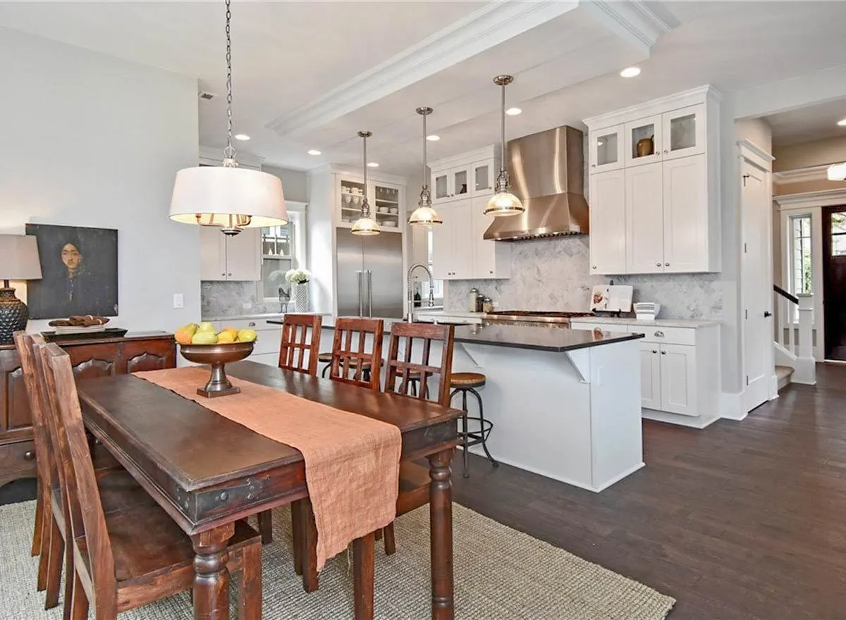 The whole view from the dining area and kitchen area that radiates modernized yet have a touch of craftsmanship house.