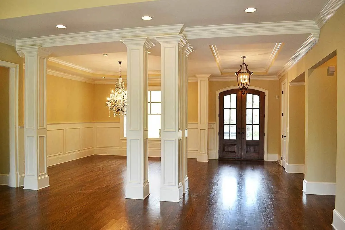 The foyer and dining room section of the house with an elegant chandelier.