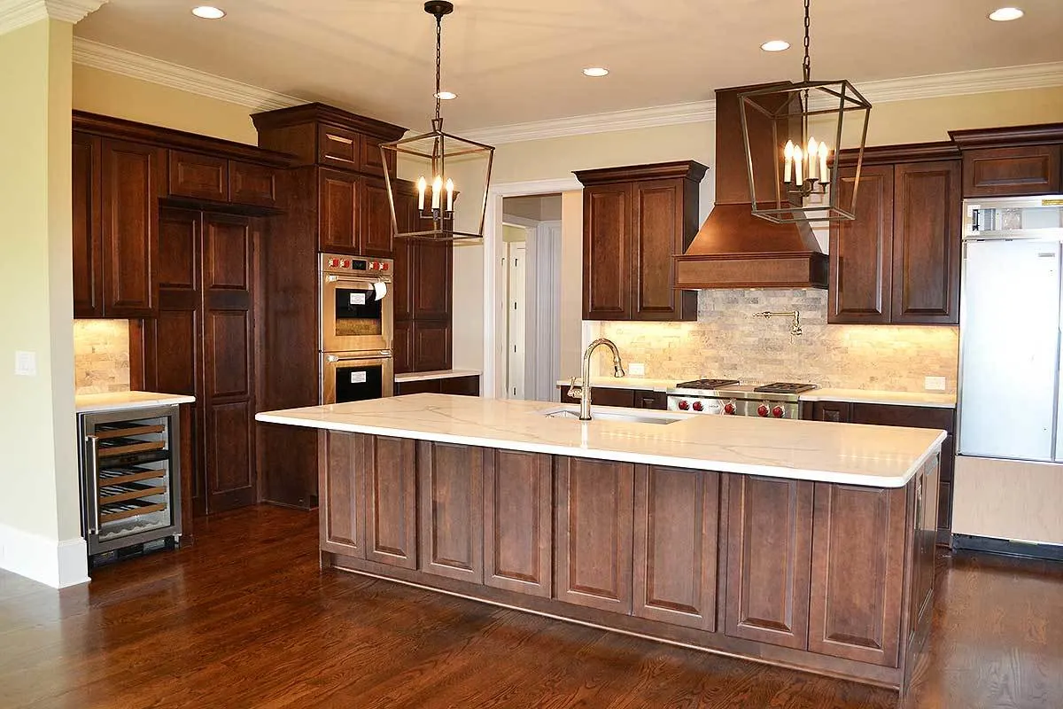 The kitchen does have a solid wood interior design and modern appliances.
