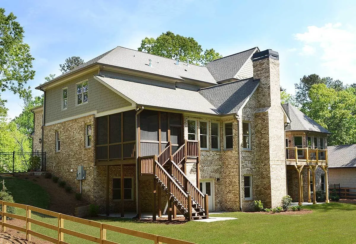 The rear layout has a screened porch space and a deck with a wooden accent design.
