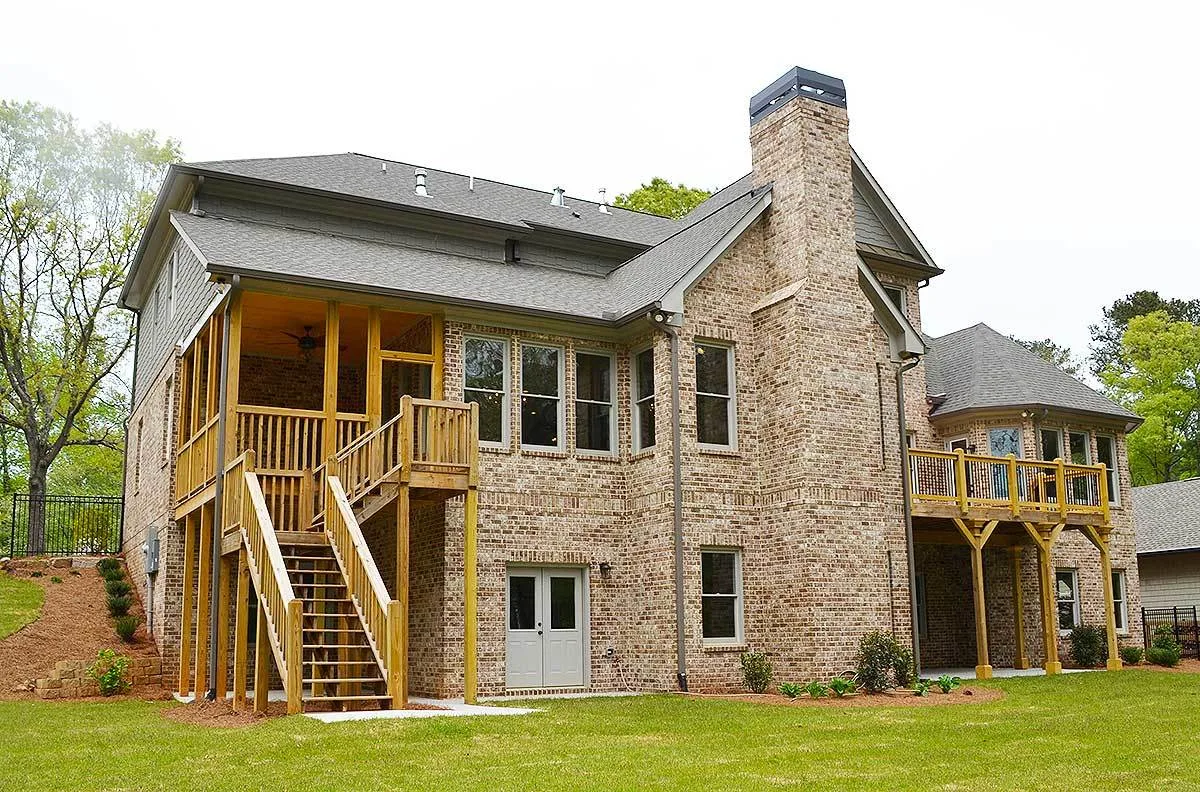 In the back exterior façade, a sturdy brick house wall stands out.