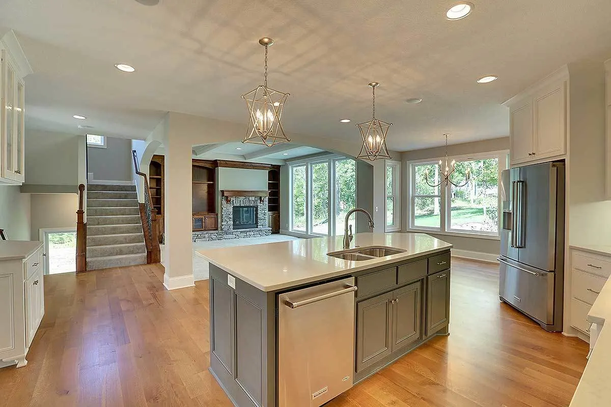 The view from the kitchen area showing the entertainment area and the staircase.