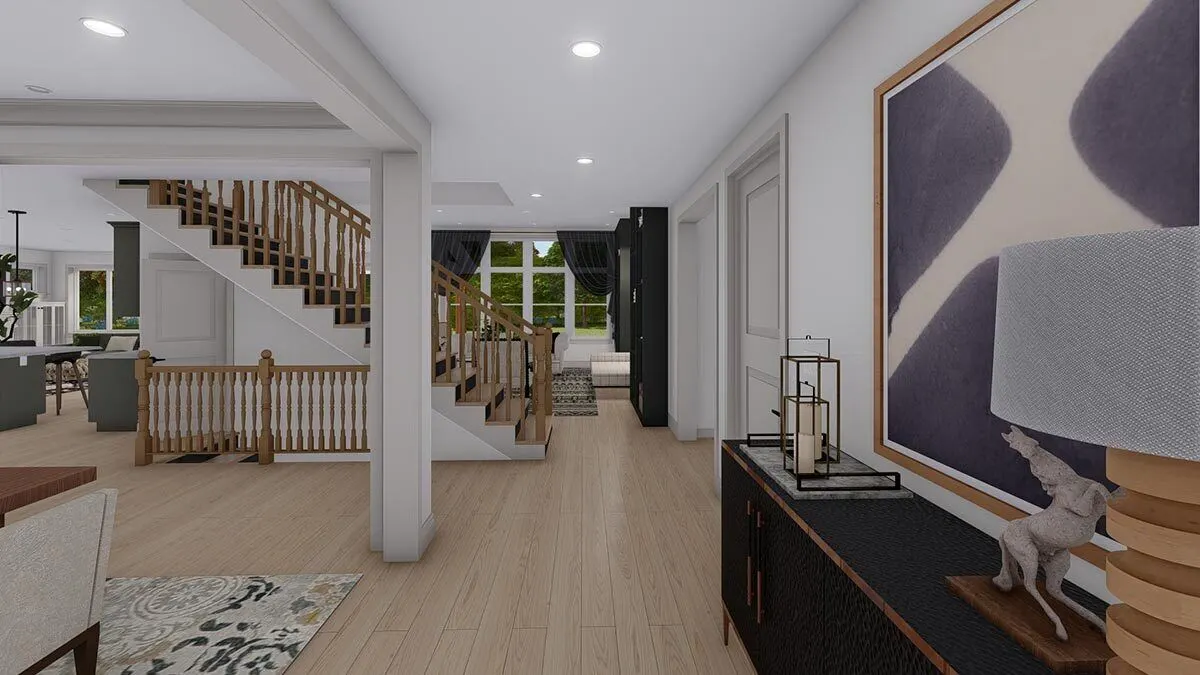 In the center of the living area, a stairway and light wooden flooring are noticeable.