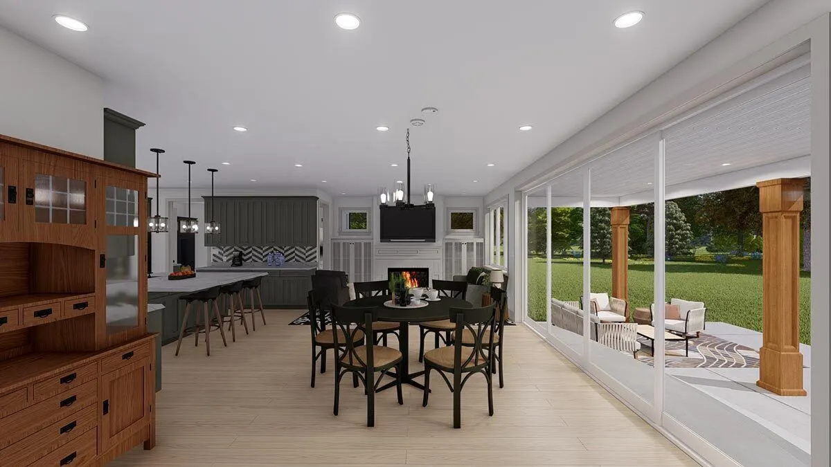 Facing the fireplace area is a round dining table with a black wooden accent.