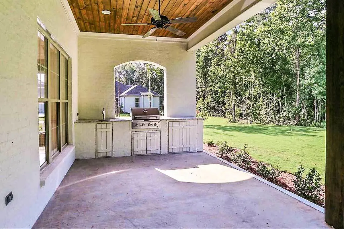 The back of the home has a grilling area and a sink.
