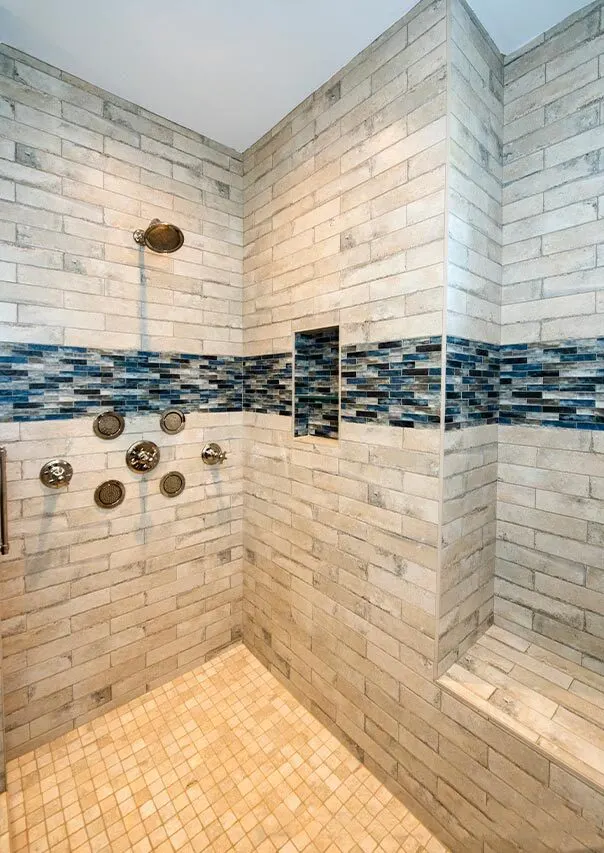 Shower area with three-tile base and a bit of blue accent color.