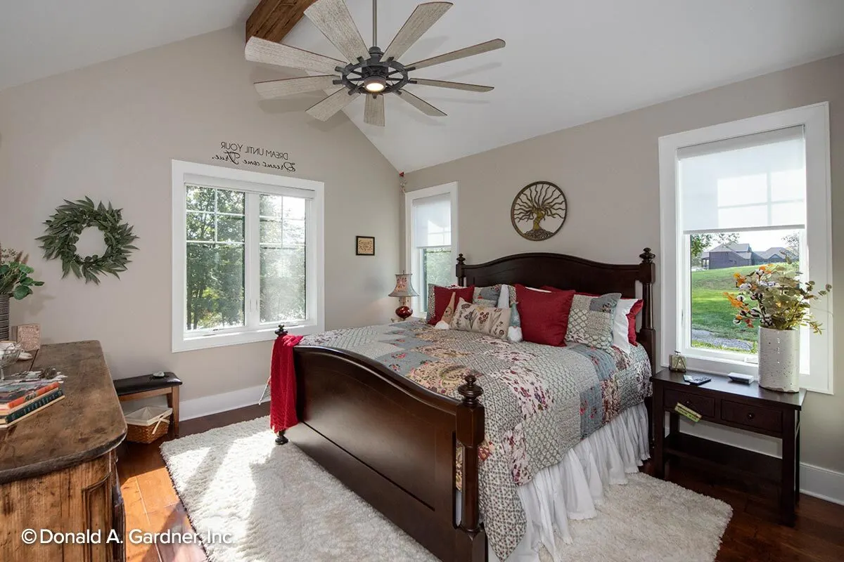A charming bedroom with windows in a white frame that adds light inside.