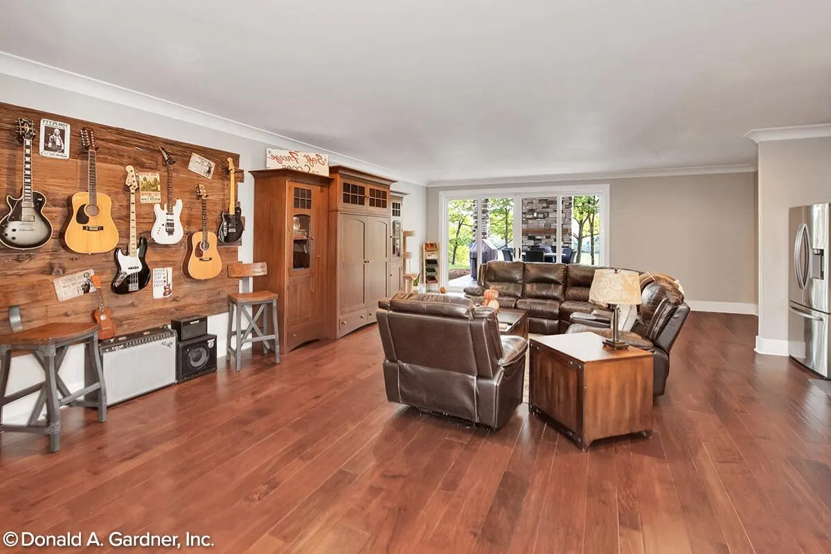 Recreational room with a spacious area in a rustic style with an instrument, and a comfortable leathered sofa set.