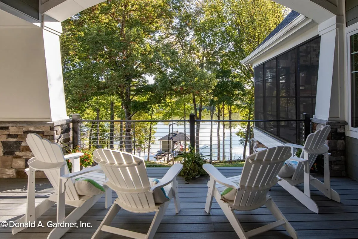 Back porch area with white wooden seats and a great view of the outdoors.