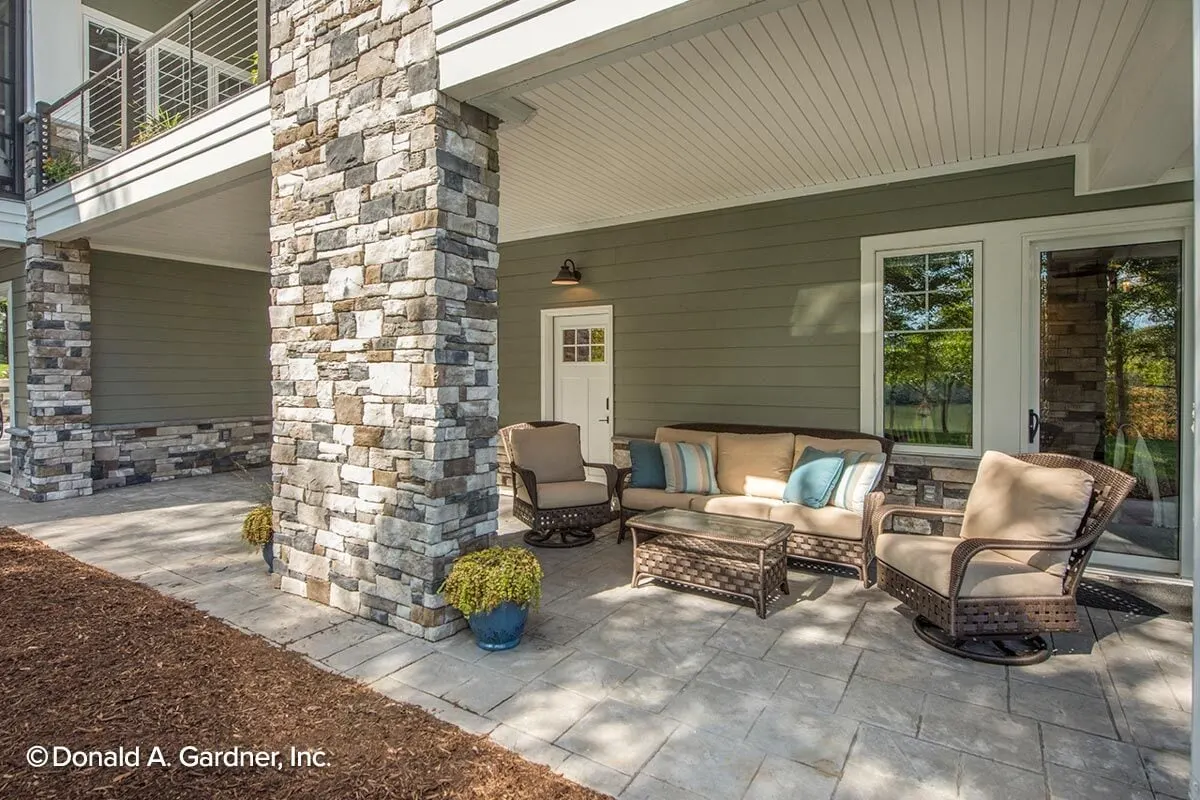 Lower level side porch area with cozy lounge chairs with door access to the bedroom.