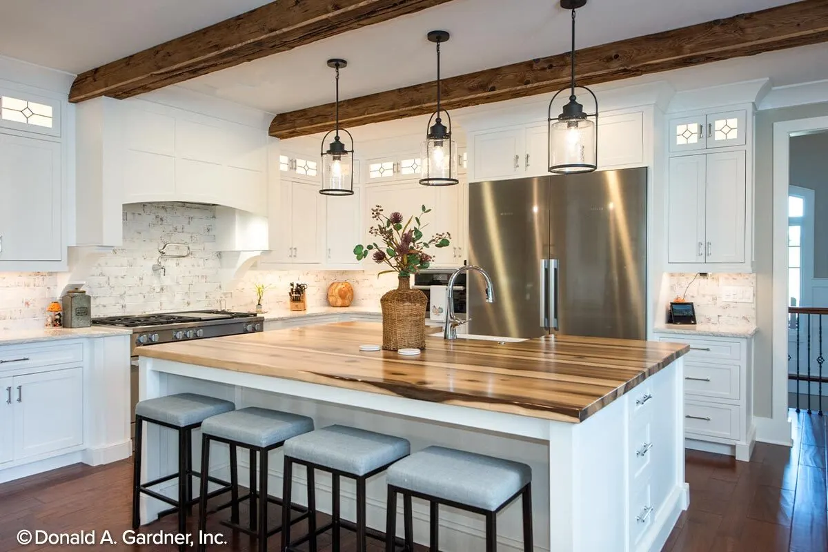 A comfortable kitchen area with a modern style and a white interior.
