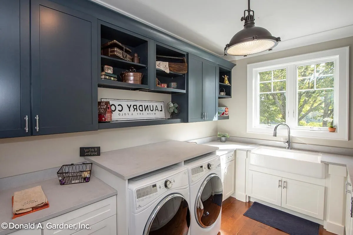 Laundry room with washer, dryer, and shelves.