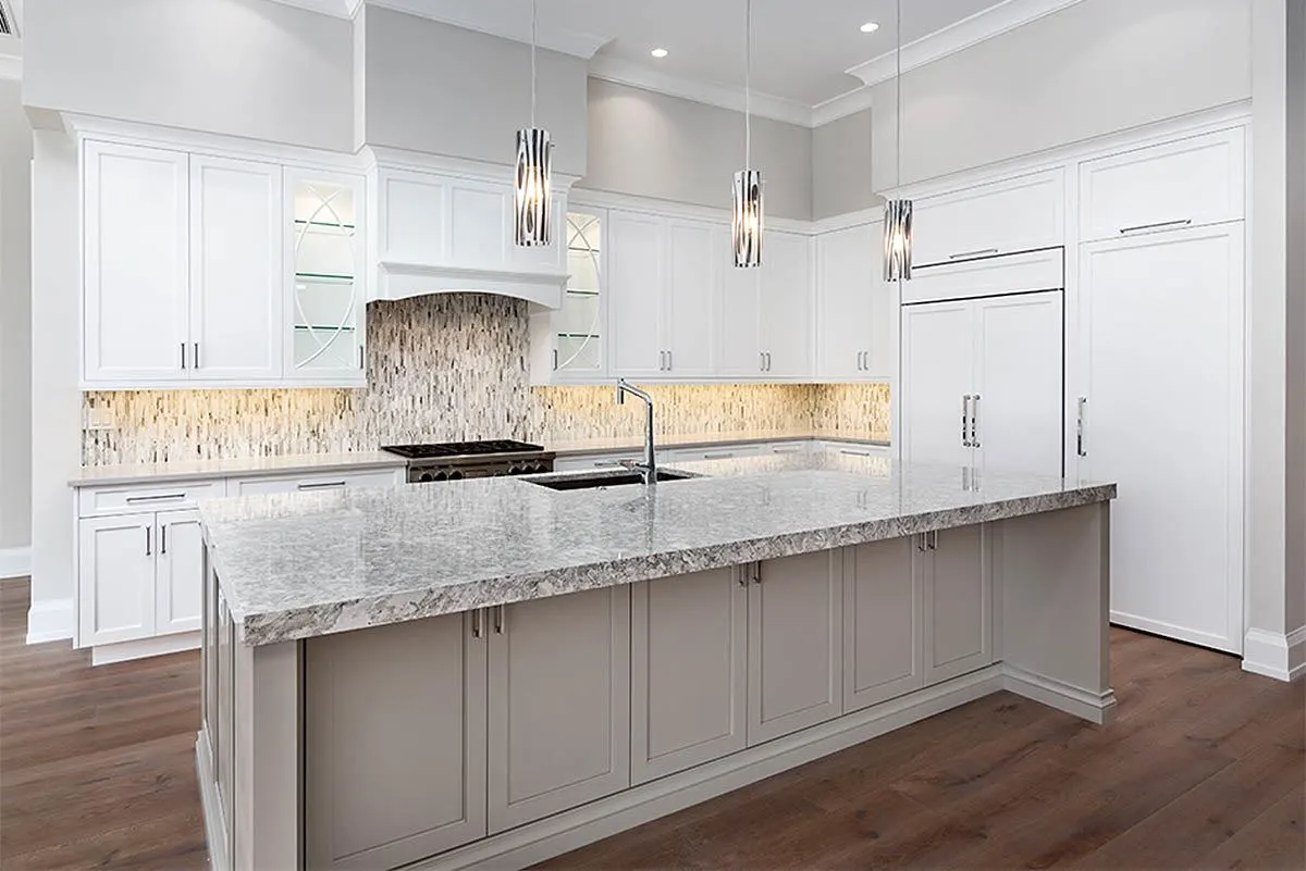 The kitchen section features a lovely backsplash design that complements the center island.