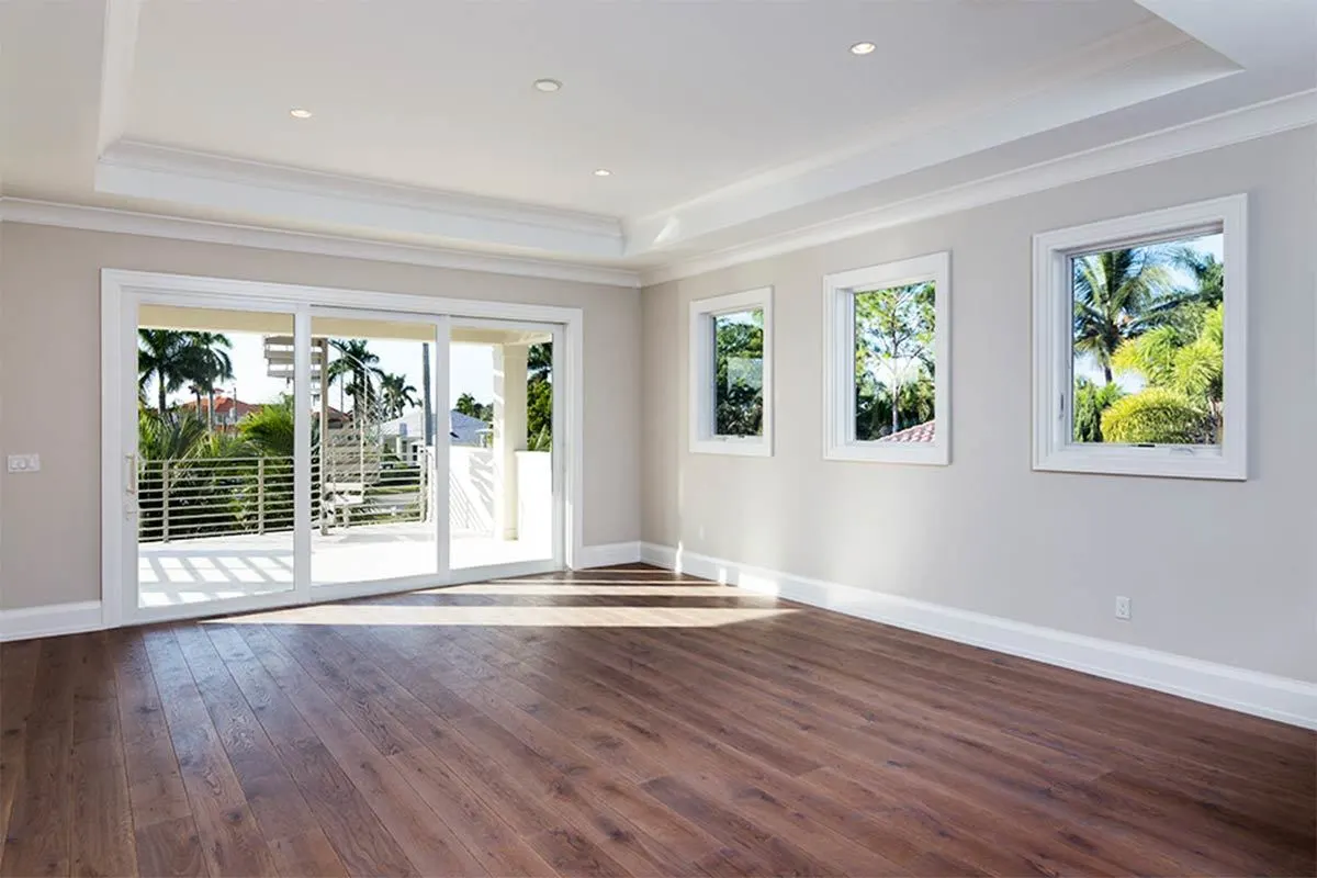 Recreational room with three glass sliding doors and white trim windows.