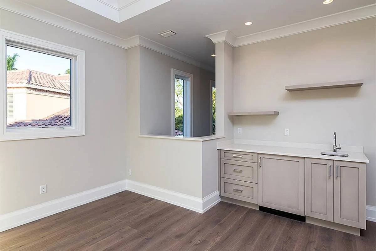 Laundry room on the second level with sink and wall-mounted racks.