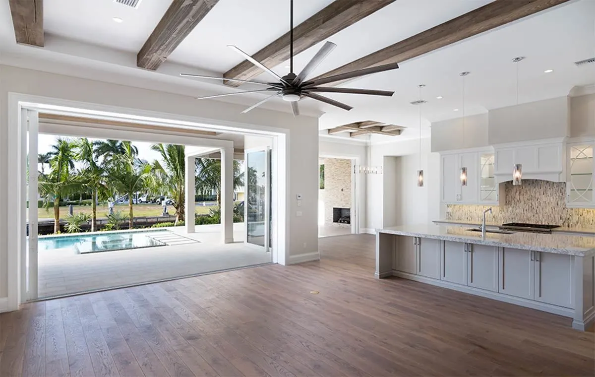 Great room layout with wooden floors and a large ceiling fan.