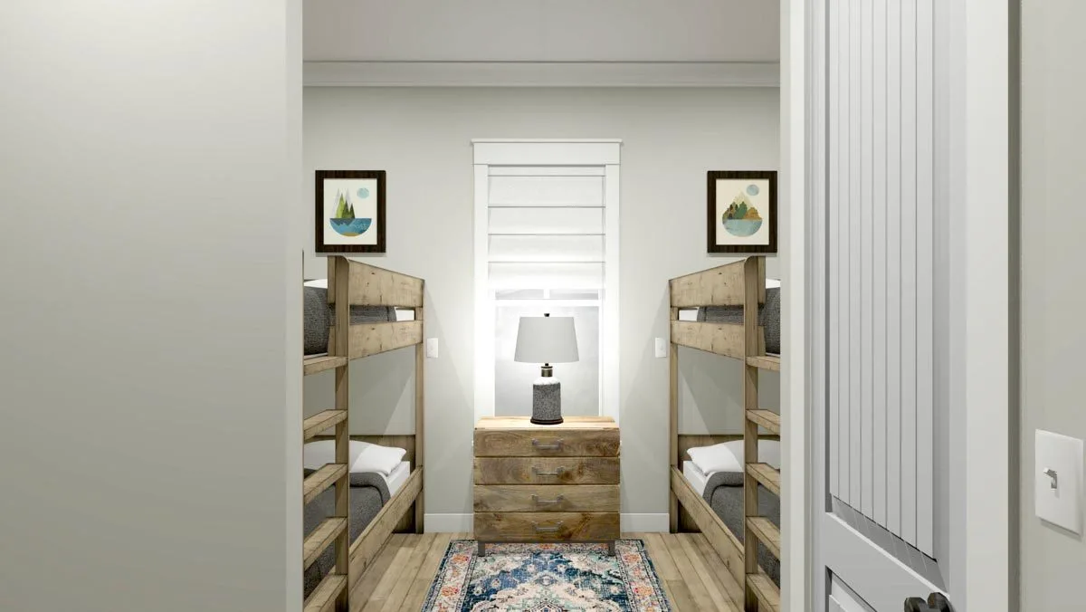 A bedroom space including wood-accented bunk beds and a central table with drawers.