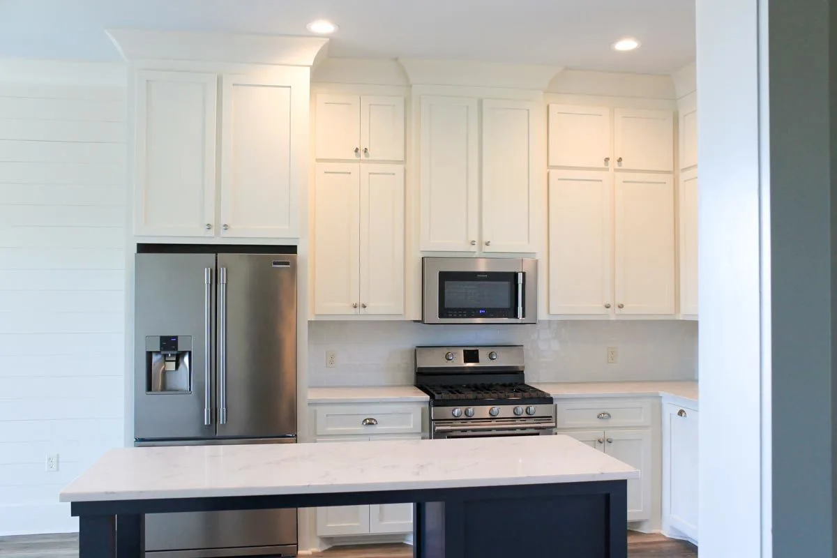 White marble countertops go well with a white tile backsplash.