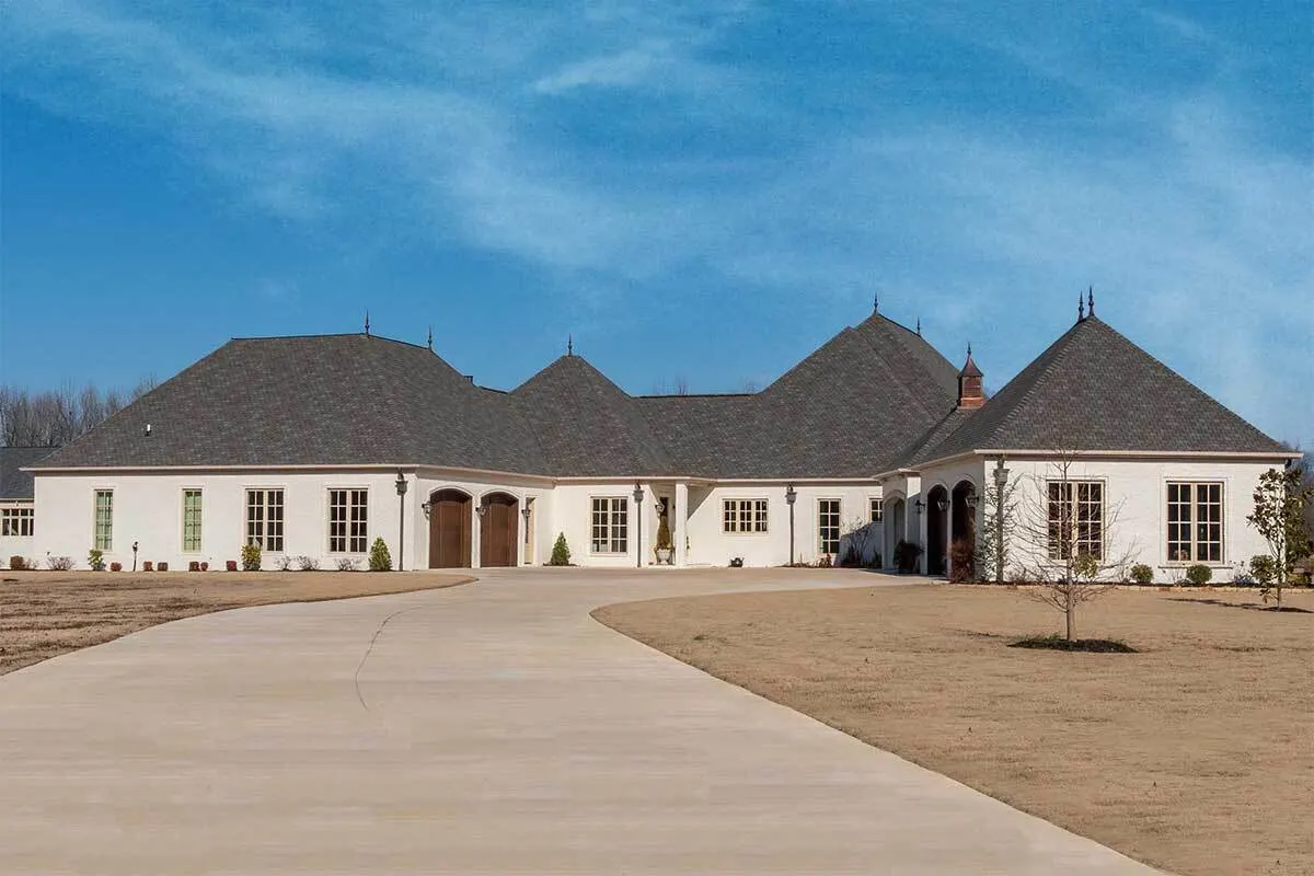 A long spacious motor court with visible 2 car garage space.