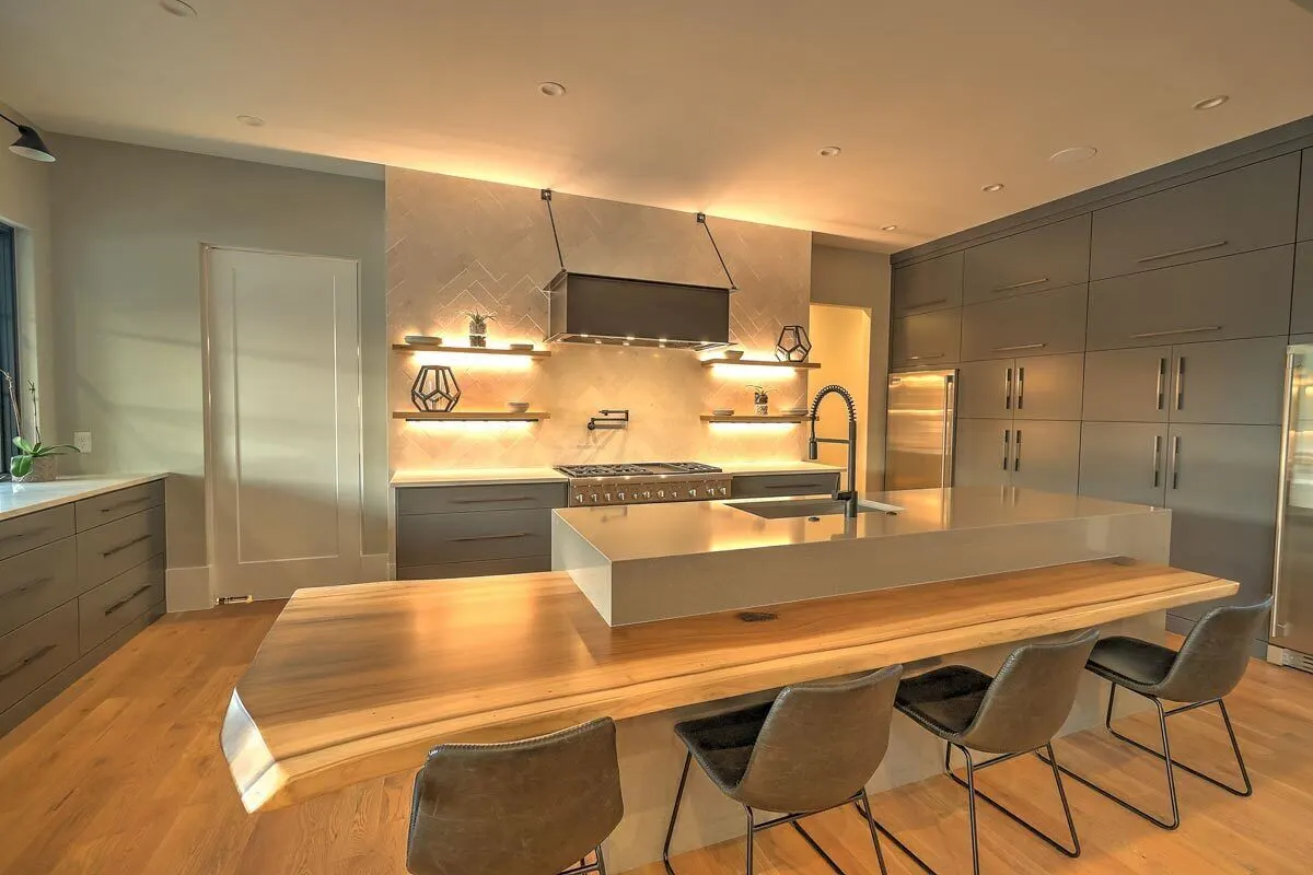 Esthetically modern island construction made of marble and wood.