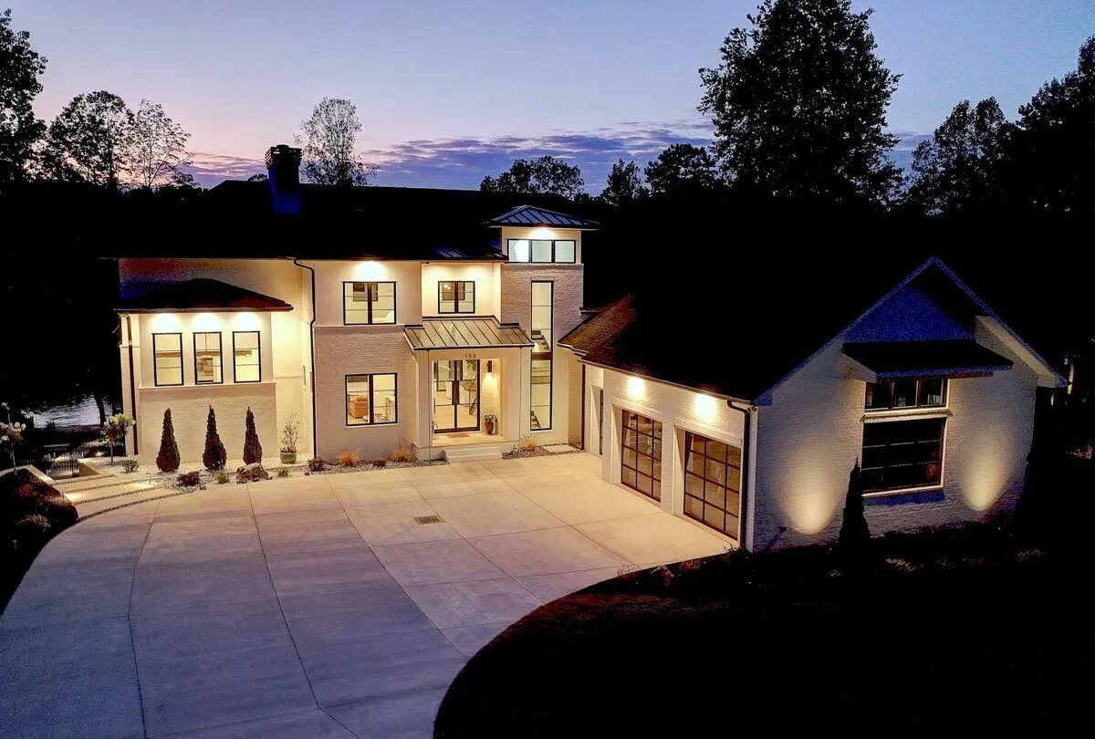 A beautiful nighttime view of the luxurious residence radiates within.