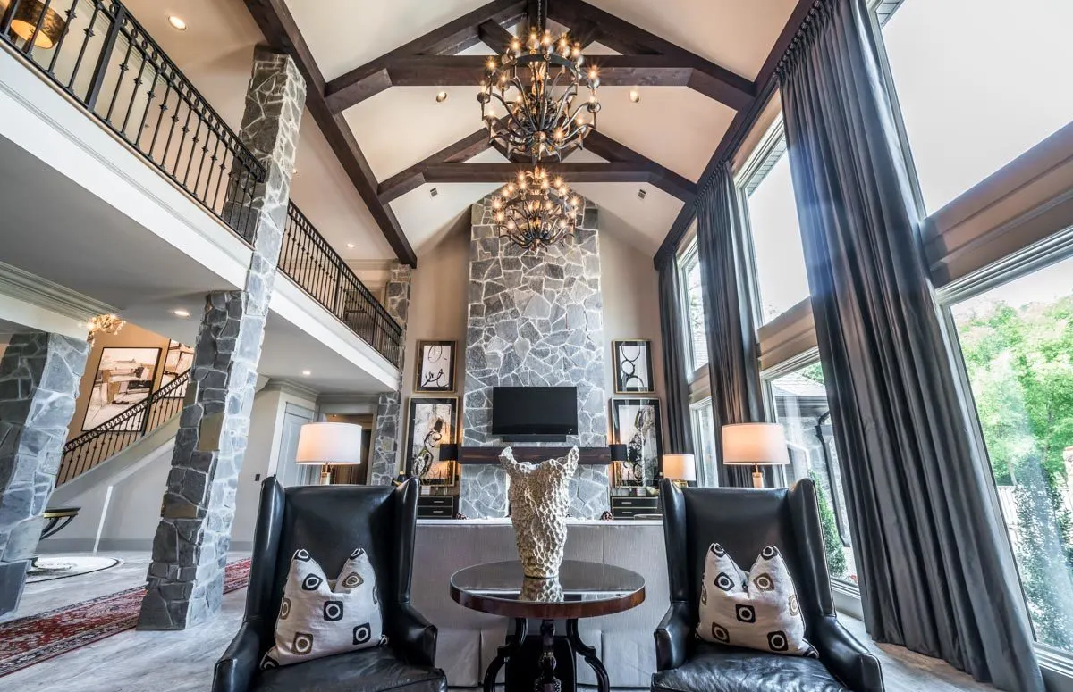 In the living room, the high stone support and fireplace stand out.