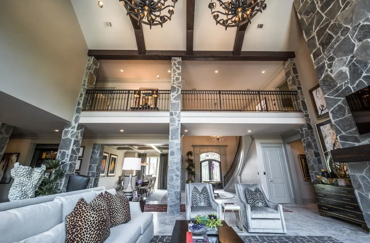 The house has a high ceiling and a great view of the balcony on the second level.