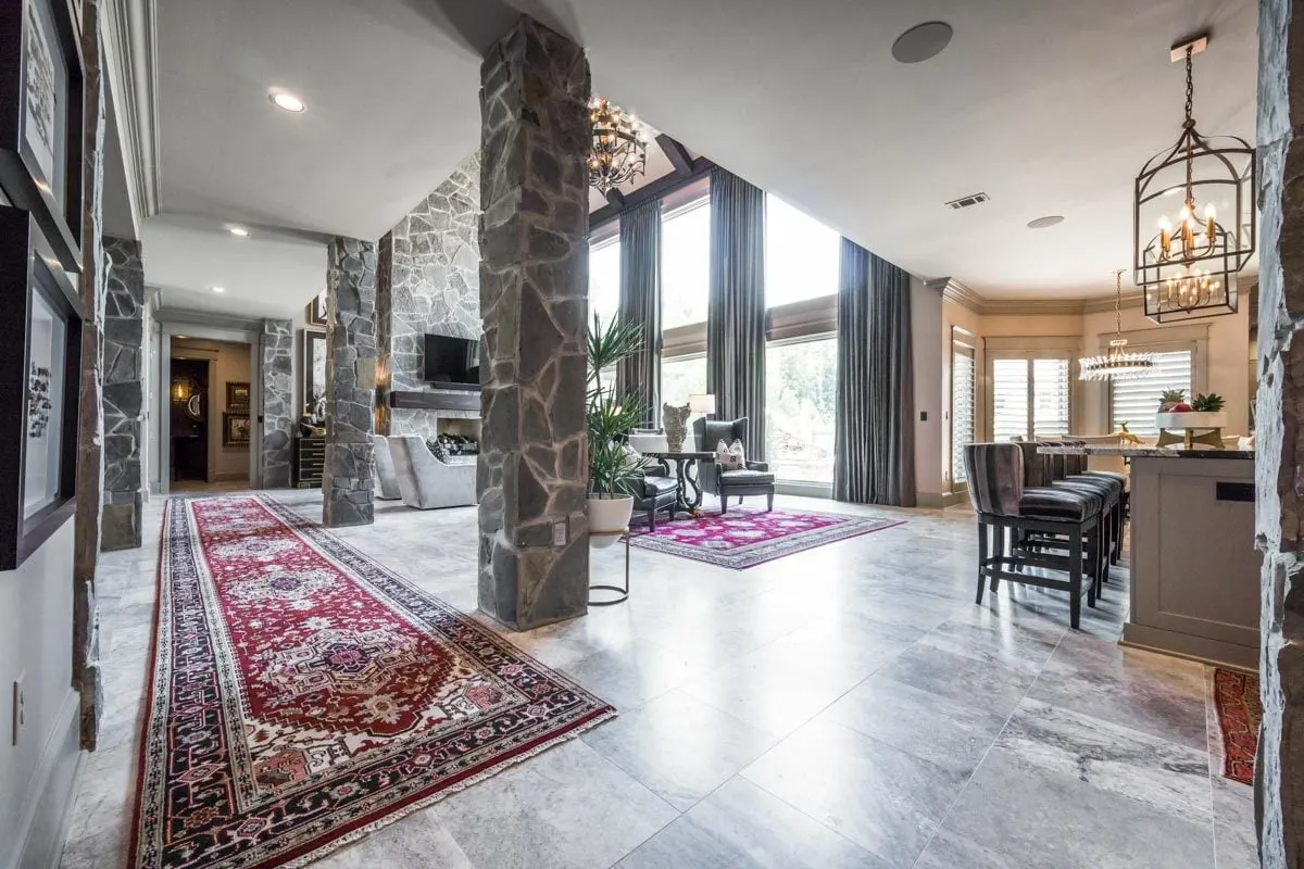 The long red carpet floor complements the stone-tiled base pattern.