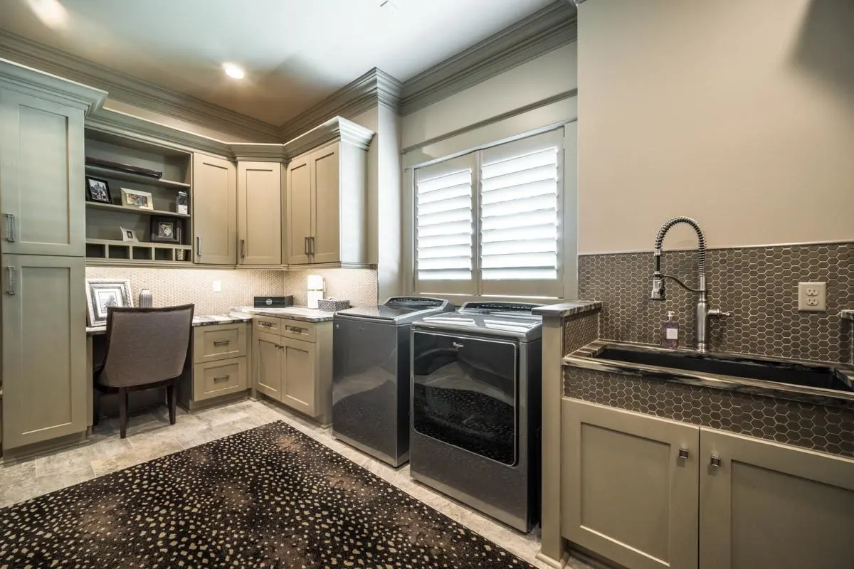 Drawers and garment storage with chair seats in the laundry room.