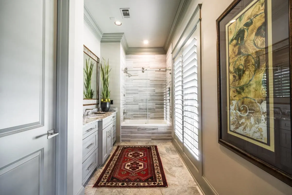 The second master bathroom has a shower area as well as vanity features.