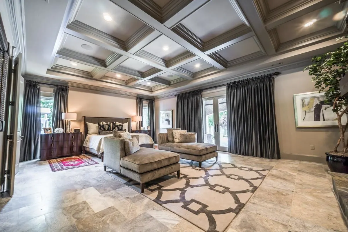 Large bedroom with a cozy ambiance and a high ceiling style.