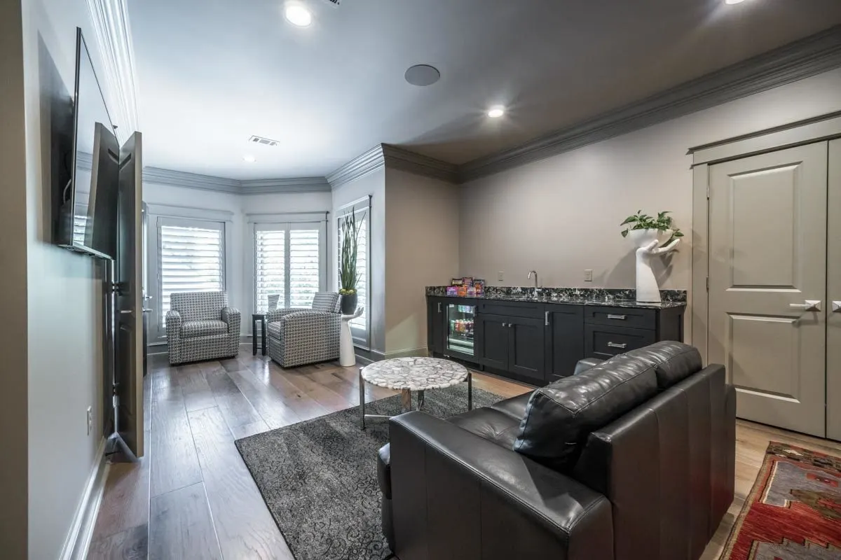 The second floor has a sitting area with a wet bar.
