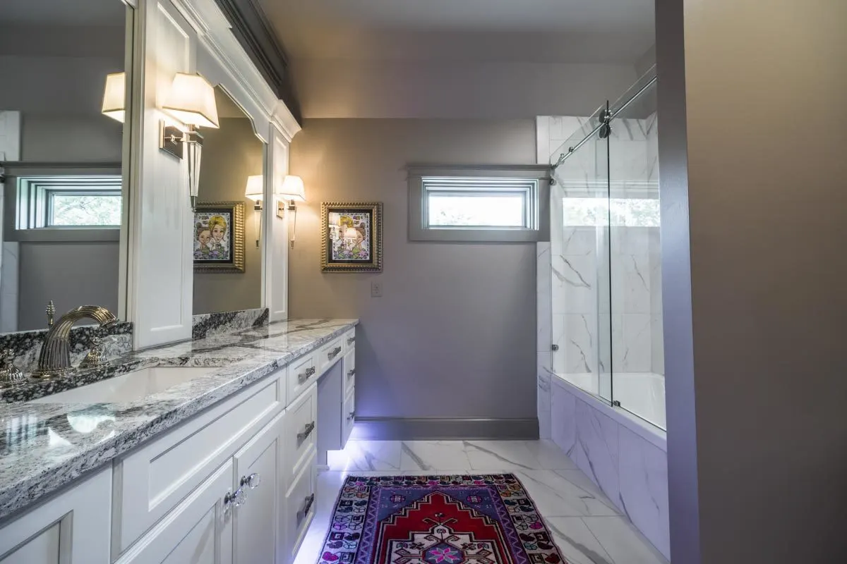 Another bedroom's bath is decorated in gray tones.