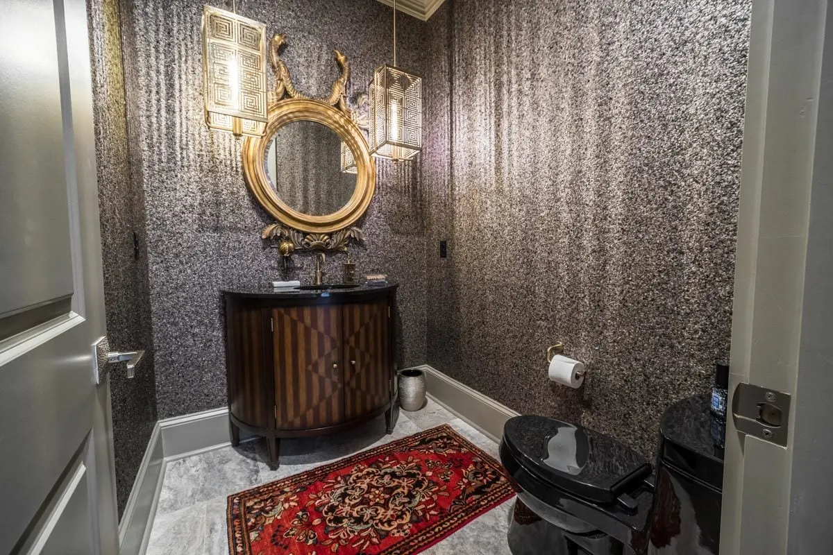 Luxurious guest bathroom space with unique mirror and light style.